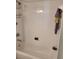 Clean white tiled shower and tub combination with shower caddy and green walls at 1318 Misty Greens Dr, Sun City Center, FL 33573