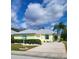 Charming single-story home with a well-manicured lawn, a two car garage, and a welcoming front entrance at 1318 Misty Greens Dr, Sun City Center, FL 33573