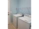 Laundry room featuring new white appliances and storage shelves for convenience at 1318 Misty Greens Dr, Sun City Center, FL 33573