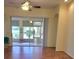 Bright living room featuring hardwood floors and a large glass door leading to the lanai at 1318 Misty Greens Dr, Sun City Center, FL 33573