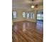Open living space with hardwood floors, bright windows, and a view of the lanai at 1318 Misty Greens Dr, Sun City Center, FL 33573