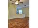 Open-concept living area with hardwood floors, connecting to the kitchen and dining spaces at 1318 Misty Greens Dr, Sun City Center, FL 33573