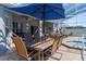 Outdoor patio with table seating, grill and jacuzzi, perfect for outdoor entertaining by the pool at 13424 Hunters Point St, Spring Hill, FL 34609