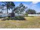 Large backyard with vinyl fencing, mature trees, and storage shed at 13424 Hunters Point St, Spring Hill, FL 34609