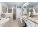 This is a spacious bathroom with a dual sink vanity, a soaking tub, and a glass shower with a tiled surround at 13424 Hunters Point St, Spring Hill, FL 34609