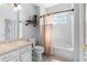 This is a bright bathroom with a large mirror, a toilet, a bathtub, and a window with curtains at 13424 Hunters Point St, Spring Hill, FL 34609