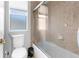 This bathroom features a toilet, a sliding glass door for the shower/tub, and a frosted window at 13424 Hunters Point St, Spring Hill, FL 34609