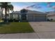Charming home with a two-car garage, lush landscaping, and mature palm at 13424 Hunters Point St, Spring Hill, FL 34609