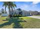 Charming single-Gathering home featuring lush landscaping, a well-manicured lawn, and a two-car garage at 13424 Hunters Point St, Spring Hill, FL 34609