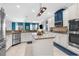 Bright, modern kitchen with stainless steel appliances, granite counters, and center island at 13424 Hunters Point St, Spring Hill, FL 34609