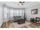 Inviting living room featuring stylish wood floors, a bay window, and recessed lighting at 13424 Hunters Point St, Spring Hill, FL 34609