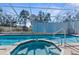 Enclosed pool area features a swimming pool, jacuzzi, and plenty of room to relax at 13424 Hunters Point St, Spring Hill, FL 34609