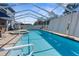 Beautiful in-ground pool with attached spa and screened-in enclosure at 13424 Hunters Point St, Spring Hill, FL 34609