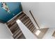 Top-down view of a staircase showcasing hardwood steps and white risers with natural light at 13424 Hunters Point St, Spring Hill, FL 34609