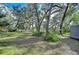 Large backyard with mature trees provides a private, serene outdoor space with ample room for activities and relaxation at 13908 Paradise Ln, Dade City, FL 33525