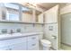 Bright bathroom featuring retro tilework, classic fixtures, and ample vanity storage at 13908 Paradise Ln, Dade City, FL 33525