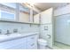 Charming bathroom featuring retro tilework, classic fixtures, and ample vanity storage at 13908 Paradise Ln, Dade City, FL 33525