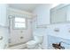 Bathroom with retro tilework, featuring a shower/tub combo, awaiting renovation at 13908 Paradise Ln, Dade City, FL 33525