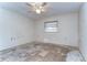 Spacious bedroom with ceiling fan and natural light from window, ready for renovation at 13908 Paradise Ln, Dade City, FL 33525