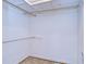 Walk-in closet with hanging rods and open ceiling at 13908 Paradise Ln, Dade City, FL 33525