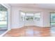 Bright dining area with hardwood floors, bay windows, and sliding glass door at 13908 Paradise Ln, Dade City, FL 33525