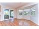 Dining area with hardwood floors, bay windows, and a sliding glass door leading to a patio at 13908 Paradise Ln, Dade City, FL 33525