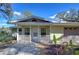 Charming home with a cozy front porch and well-maintained landscaping, creating a welcoming curb appeal at 13908 Paradise Ln, Dade City, FL 33525