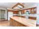 Charming kitchen featuring knotty pine cabinets, butcher block island, and abundant natural light at 13908 Paradise Ln, Dade City, FL 33525