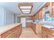 Well-equipped kitchen featuring knotty pine cabinets, butcher block island, and modern appliances at 13908 Paradise Ln, Dade City, FL 33525