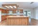 Knotty pine cabinets, butcher block island, and hardwood floors in a bright and airy space at 13908 Paradise Ln, Dade City, FL 33525