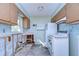 Bright kitchen with white appliances and white cabinetry at 13908 Paradise Ln, Dade City, FL 33525