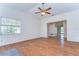 Living room with hardwood floors, ceiling fan, and views into the connecting rooms at 13908 Paradise Ln, Dade City, FL 33525