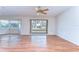 Open living room boasting hardwood floors, ceiling fan and bay windows at 13908 Paradise Ln, Dade City, FL 33525