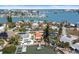 Stunning aerial view of waterfront homes showcasing private docks and beautiful landscaping on the open water at 14184 W Parsley Dr, Madeira Beach, FL 33708