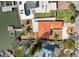 Expansive aerial view of the home featuring a vibrant orange roof, private pool, and a lush landscape at 14184 W Parsley Dr, Madeira Beach, FL 33708