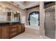 Bathroom featuring tub, vanity with dark countertop, decorative lighting, and separate glass shower at 17104 Tiffany Lake Pl, Lutz, FL 33549