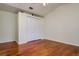 Bright bedroom with hardwood floors, a closet with white doors, and a ceiling fan at 17104 Tiffany Lake Pl, Lutz, FL 33549