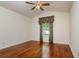 Inviting bedroom with hardwood floors, a ceiling fan, and decorative curtains at 17104 Tiffany Lake Pl, Lutz, FL 33549