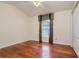 Well-lit bedroom with hardwood floors, a ceiling fan, and window with decorative curtains at 17104 Tiffany Lake Pl, Lutz, FL 33549