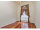 Elegant dining room with hardwood floors, a chandelier, and decorative curtains at 17104 Tiffany Lake Pl, Lutz, FL 33549