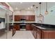 Gourmet kitchen featuring stainless steel appliances, granite countertops, and tile flooring at 17104 Tiffany Lake Pl, Lutz, FL 33549