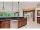Well-appointed kitchen with dark countertops, stainless steel appliances, and decorative hanging lights at 17104 Tiffany Lake Pl, Lutz, FL 33549