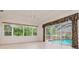 Living room with views of the yard and access to the lanai and screened-in pool at 17104 Tiffany Lake Pl, Lutz, FL 33549