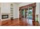 Living room features wood flooring, a fireplace, and sliding glass doors overlooking the pool at 17104 Tiffany Lake Pl, Lutz, FL 33549