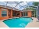 View of the pool, patio, and home showing an outdoor living space at 17104 Tiffany Lake Pl, Lutz, FL 33549