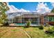 View of the home's screened in pool and manicured backyard at 17104 Tiffany Lake Pl, Lutz, FL 33549