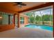 Outdoor pool featuring cool decking, screened enclosure, and a peek into the living room at 17104 Tiffany Lake Pl, Lutz, FL 33549