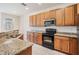 Well-equipped kitchen featuring granite countertops, stainless steel appliances, and ample wood cabinets at 26932 Juniper Bay Dr, Wesley Chapel, FL 33544