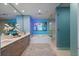 Elegant bathroom featuring modern vanity, soaking tub, glass shower, and stylish blue walls at 301 1St Street S # 1901, St Petersburg, FL 33701