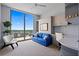 Bedroom with built-in desk and storage, showcasing a stunning city view and a cozy blue sofa at 301 1St Street S # 1901, St Petersburg, FL 33701
